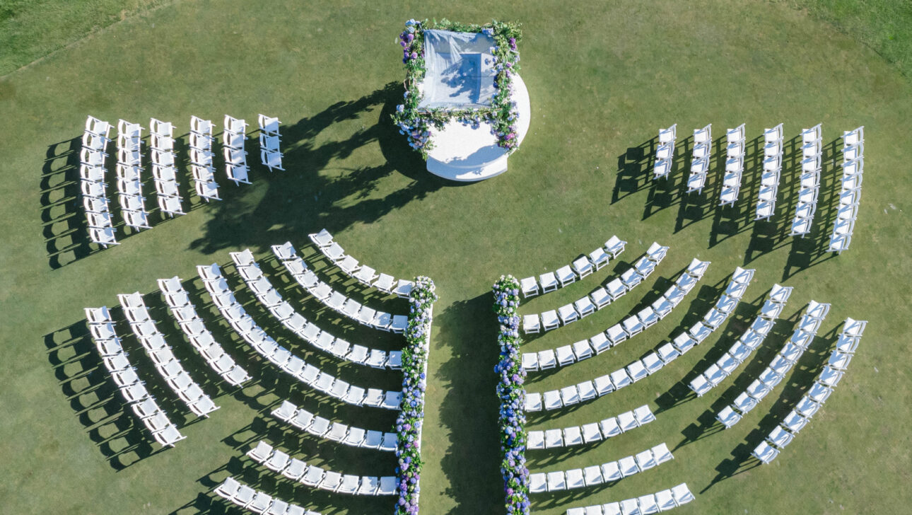 Outdoor wedding ceremony with chairs in circular pattern. Designed by Rafanelli Events.