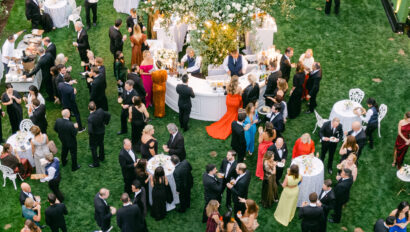 Welcome reception at wedding, wedding cocktail hour outdoors in garden. Designed by Rafanelli Events.
