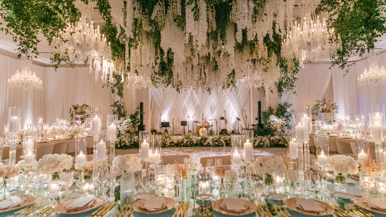 Dramatic wedding reception under a canopy of beautiful white florals. Designed by Rafanelli Events.